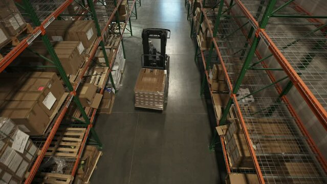 High angle view of approaching forklift driver in warehouse / American Fork, Utah, United States