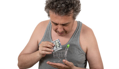 A shaggy gray-haired unshaven middle-aged man in a sleeveless T-shirt holds in his hands a 100 US...