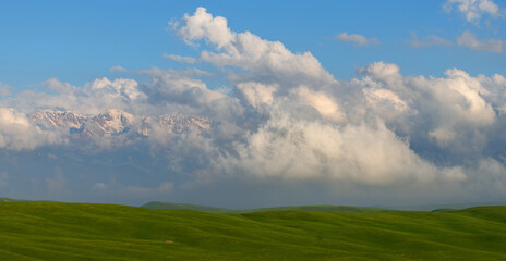 Picturesque clouds over a high mountain plateau on a spring evening