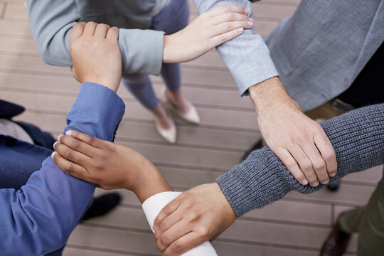 Hands, business people and arms with connect for teamwork or synergy with team huddle in outdoors. Partnership, goal and collaboration with diverse group or employees with commitment for goals.