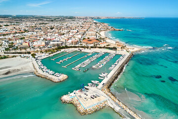 Aerial shot, drone point of view panoramic image of Torre de la Horadada townscape with sandy...