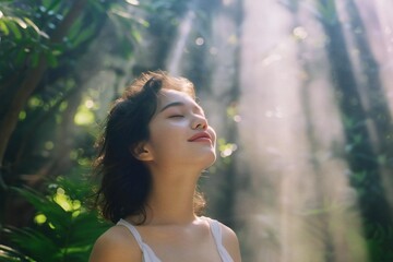 Naklejka premium Serene Young Woman Enjoying Sunlight Outdoors