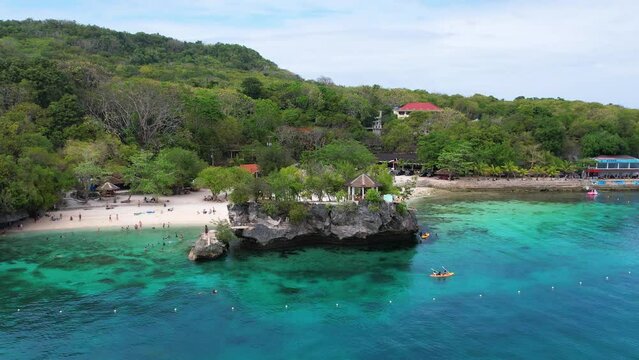 4K Aerial Drone video of famous platform jumping spot in the crystal clear turquoise water, Salagdoong beach in Siquijor island, Philippines