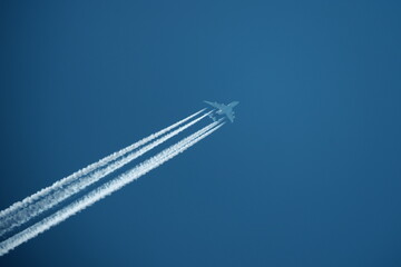 Airplane trails in the blue sky. Airplane trail on blue sky.