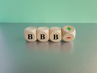 Symbol for a upgrade in a financial rating. Turned a wooden cube and changes the expression BBB...