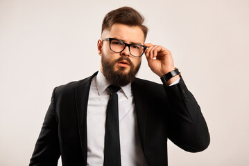 Portrait of a successful businessman on a black background. Grain effect used