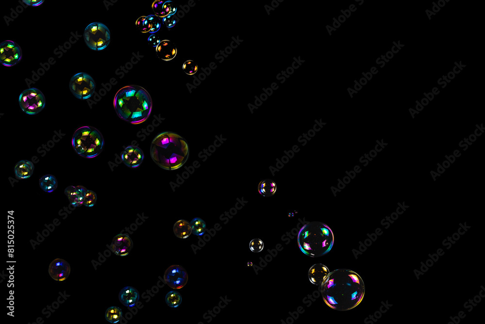 Wall mural Soap bubbles isolated on a black background