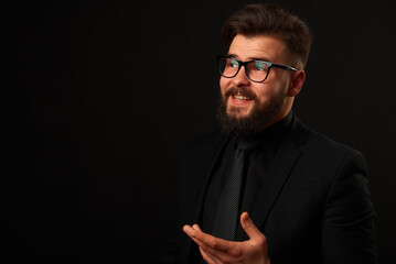 Portrait of a successful businessman. The man is dressed in a suit, black shirt and tie. Grain effect used