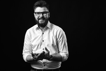 Emotional portrait of a man with a beard in a white shirt and glasses.