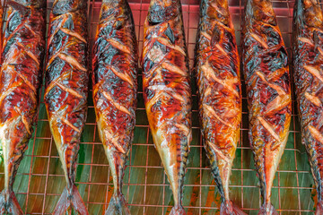 grilled mackerel fish, street food market, selective focus