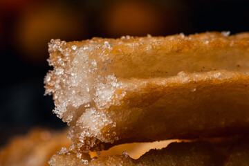 close-up of hot crocane flour churros fried in oil