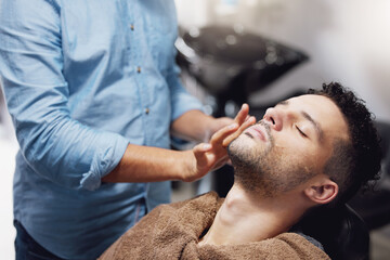 Fototapeta premium Barber, man and salon for grooming client in barbershop with hands, person and skincare. Professional Hairdresser, face and antiaging or groom for moustache treatment, self care and customer haircare
