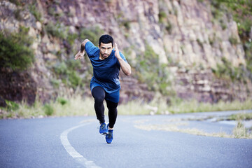 Mountain, running and man exercise on road with speed on path in summer for fitness and cardio...