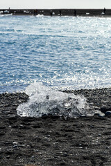 the famous black diamond beach with the beautiful small ice boulders in Jökulsárlón, Iceland