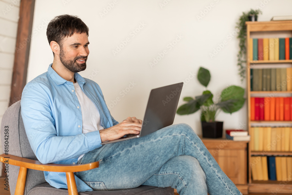 Aufkleber a man is seated in a chair, focused on a laptop computer screen. his hands are typing on the keyboar