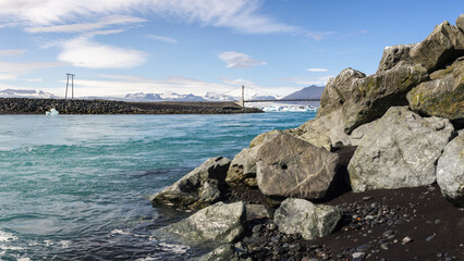 the bridge called white gate bridge over the Jökulsárlón river with glaciers and icebergs...