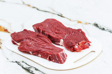 Raw meat for steak on cutting board. Top view.