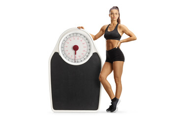 Fit female athlete with a big weight scale