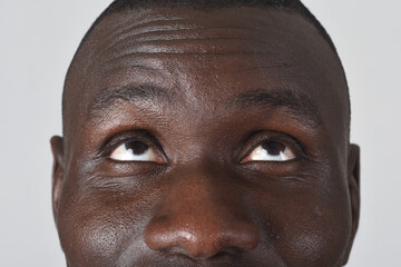 front  view of a detail of a man's eyes look up