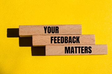 Your feedback matters written on wooden blocks with yellow background. Conceptual your feedback...