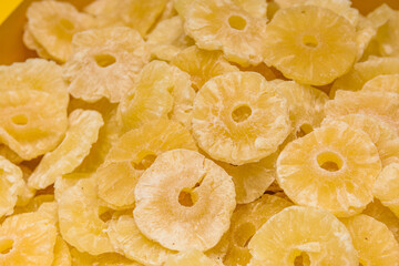 Dried preserved pineapple fruits. Background of the candied fruit slices