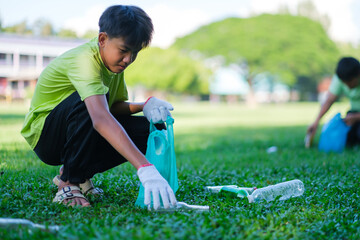 Teenagers picking up water bottles of trash cleaning up school yards and recycling plastic. ...