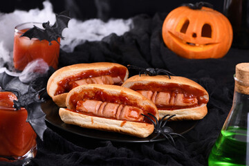 Plate of hot dogs Bloody fingers on a Halloween table