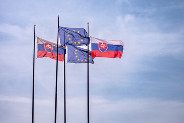 Flags of the Slovak Republic and the European Union in the wind.