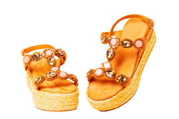 Leather shoes isolated. Close-up of a pair of elegant female suede sandals with rhinestones....