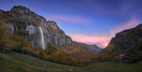 Waterfall in the birth of the river Ason, Cantabria, Spain on an autumn morning at sunrise