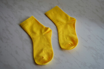 Yellow socks on a gray background. Mockup.