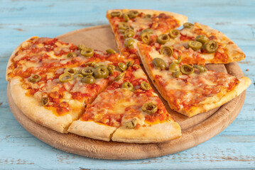 Olive Cheese Pizza on textured wood background.	