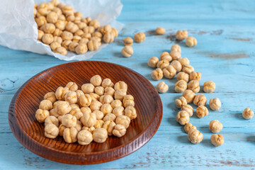 Crispy Roasted Chickpeas on wooden background. Healthy snack.