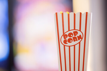 Popcorn bucket with blurred cinema background