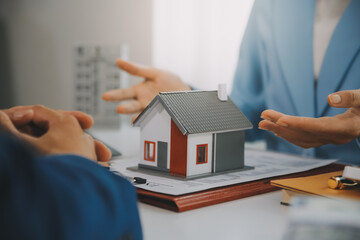 Real estate agent talked about the terms of the home purchase agreement and asked the customer to sign the documents to make the contract legally, Home sales and home insurance concept.