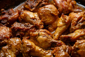 chicken breast pieces in a frying pan stewed in sauce and spices