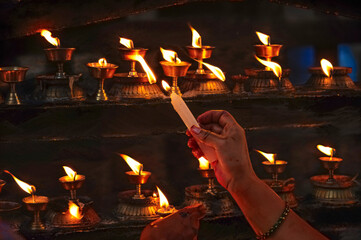 Lighting prayer candles in a Buddhist temple