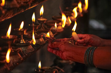 Lighting prayer candles in a Buddhist temple