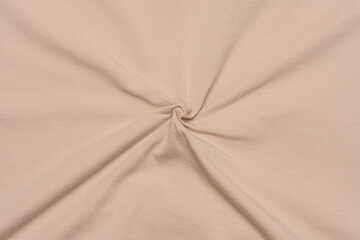 Fototapeta premium Beige knitted fabric for tailoring, full frame