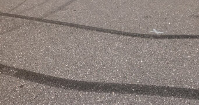 tire tracks during dangerous driving on the road , wheel streaks from sudden braking and drifting on an asphalt road