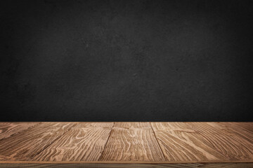 Rough wooden table with black wall background