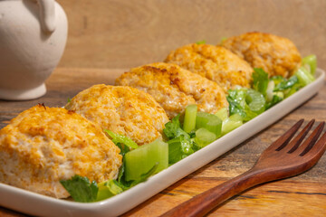 Chicken patties or cutlets served with celery. Keto diet.