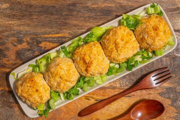 Chicken patties or cutlets served with celery. Keto diet.