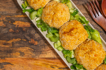 Chicken patties or cutlets served with celery. Keto diet.	