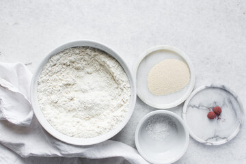 Mise en place of ingredients for making bread, All purpose flour salt and yeast on a marble...