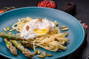 Delicious hearty breakfast consisting of poached eggs on toast with cream cheese, asparagus