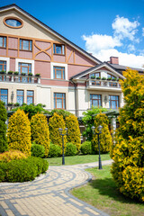 elements of landscape design. country house hotel. beautiful lawn with ornamental trees and benches