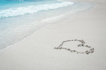beautiful drawing on the sand near the sea shore background