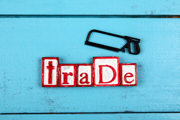 TRADE. Miniature saw on a blue wooden background. construction and carpentry concept