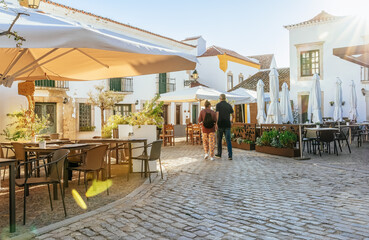 Algarve, Portugal - Tourist people  walk on a old town streets at Faro